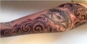 Sleeve tattoo with eye and wave design on Rita Gutierrez-Garcia’s arm.